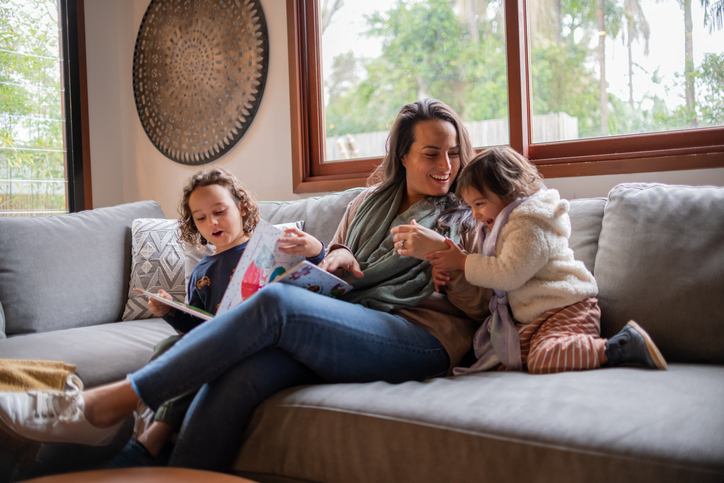 Family relaxing on a lounge in a modern Harrington Grove home